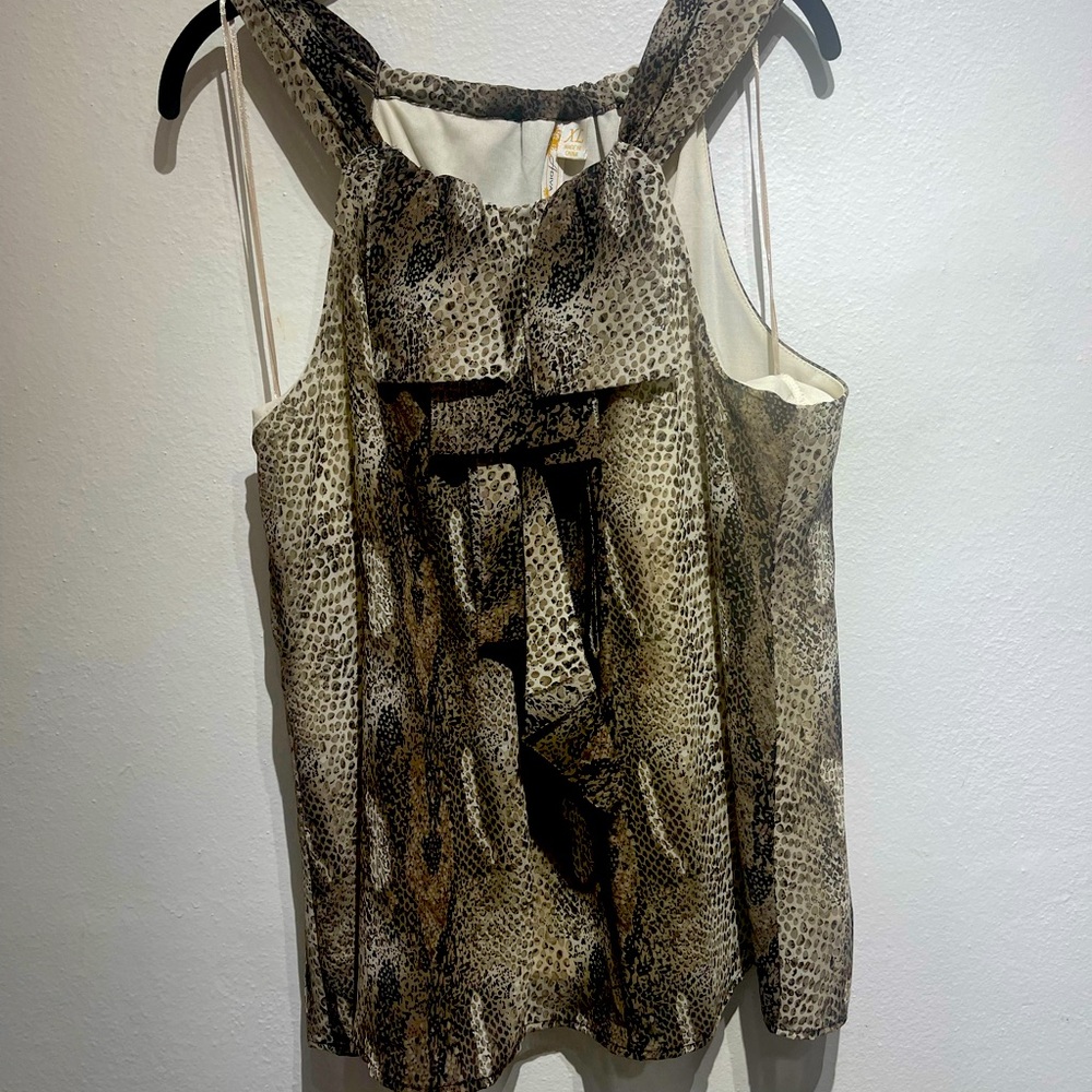 Beautiful animal print top with very cute and flattering ruffles on top.